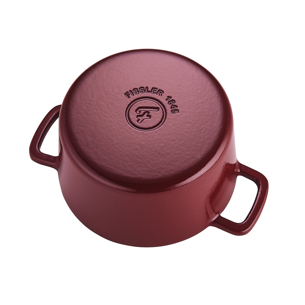 The inverted red Fissler Moments cast iron pot features two handles and the embossed 1845 logo, reflecting German precision and design.
