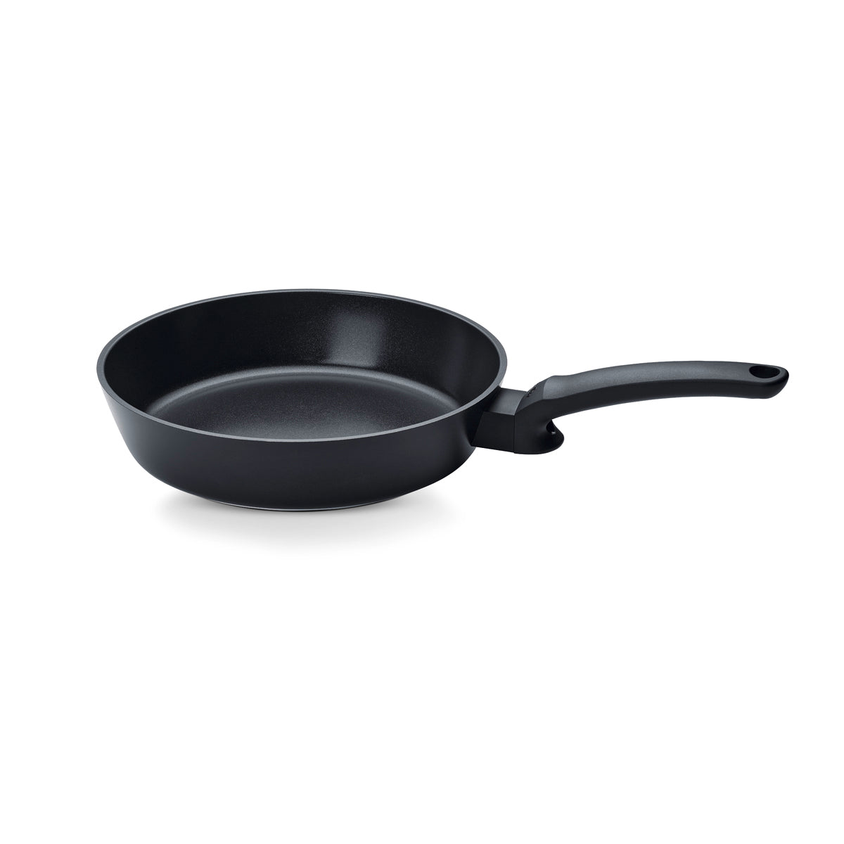 The Fissler Ceratal® Evo Comfort Pfanne, a black nonstick pan, angled to show its interior and precision "Made in Germany" design.
