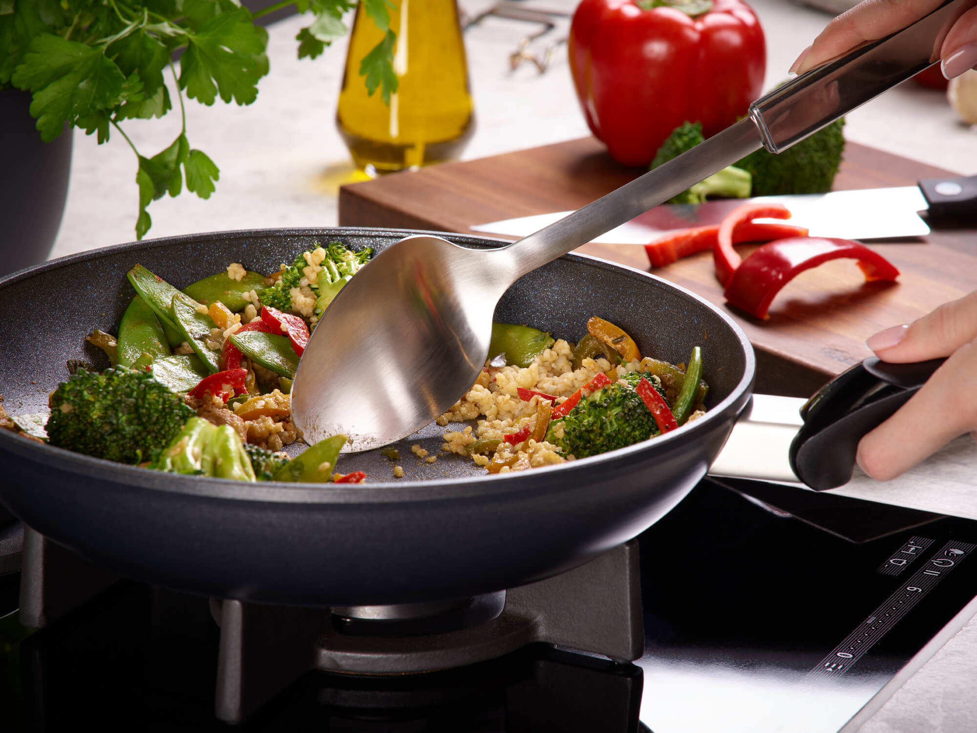 Fried vegetables and rice in Fissler Adamant® Classic pans with Non-Stick Coating, made in Germany, with fresh herbs and peppers.