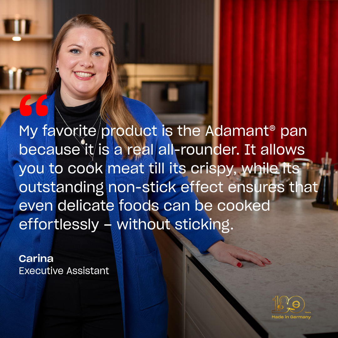 In a modern kitchen, a smiling woman in a blue jacket stands beside her favorite Fissler Adamant® non-stick pan. Beside her appear a quote expressing her appreciation for the pan’s durability and performance, her name—Carina, Executive Assistant—and the iconic "Made in Germany" logo. The scene highlights Fissler’s legacy of precision-engineered cookware and timeless German craftsmanship.