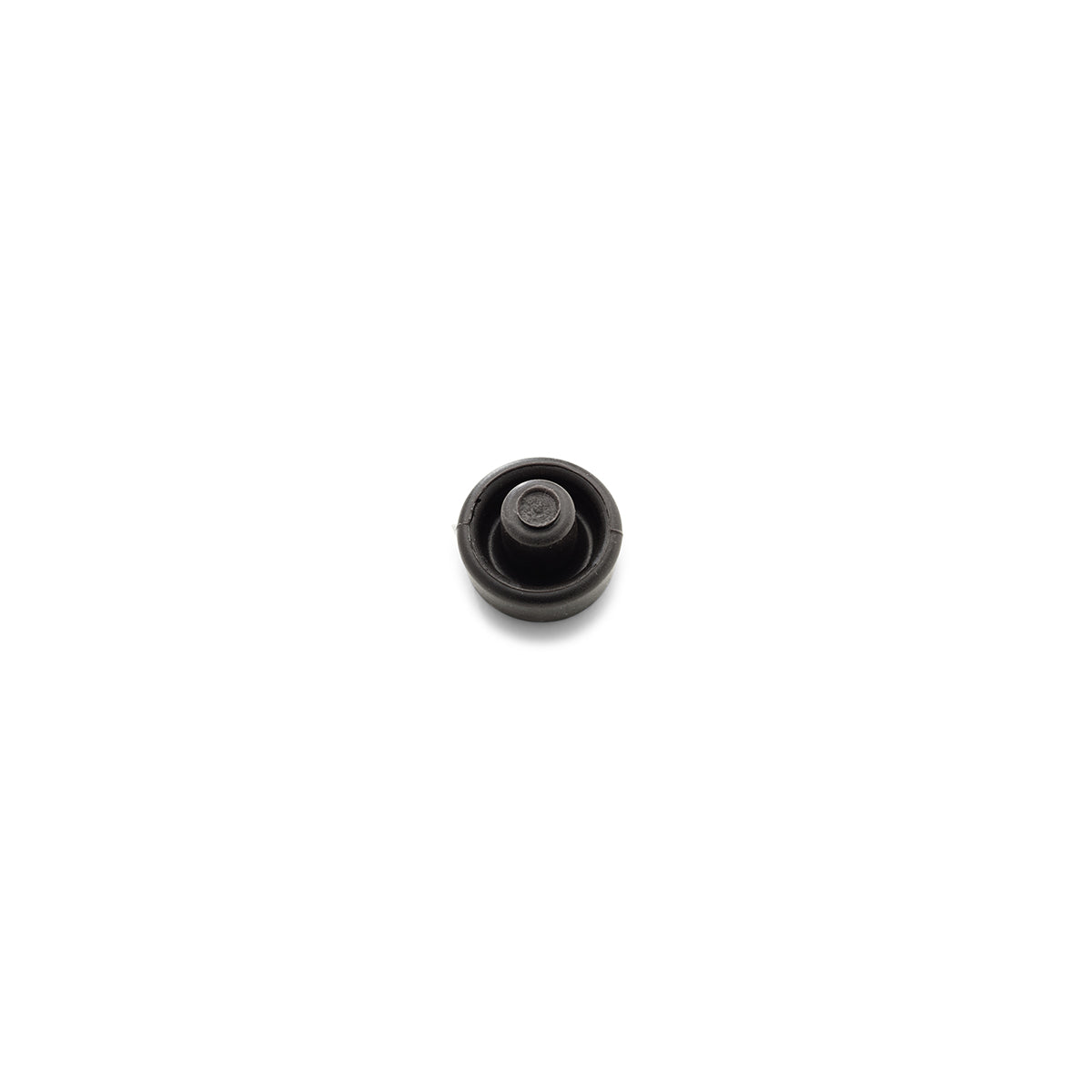 Simple black cylindrical Fissler roll membrane stopper with raised center, photographed on a white precision part for Fissler pressure cookers.