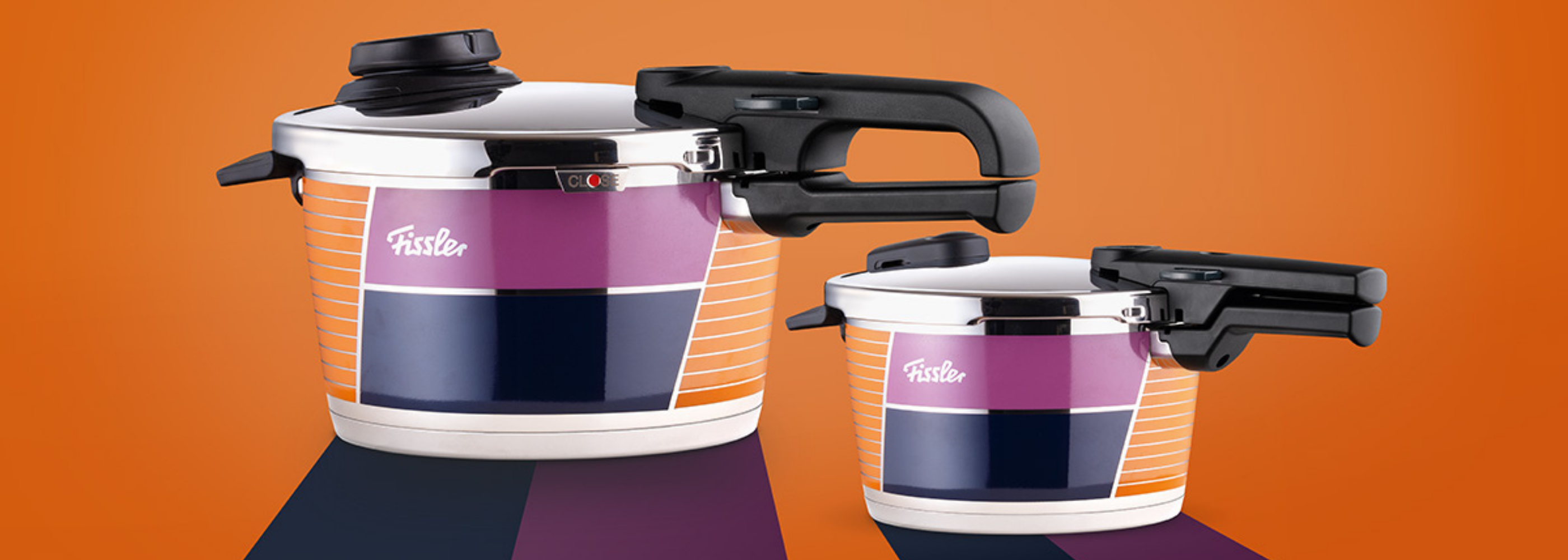 Fissler stainless steel pressure cookers with black handles and colorful geometric patterns on an orange background.