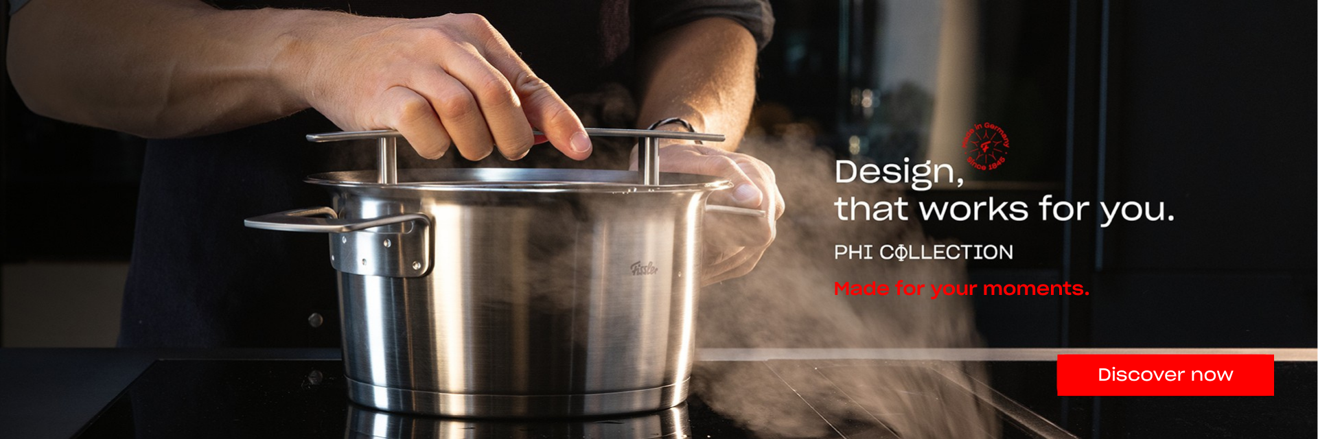 A person lifts the lid from a steaming Fissler stainless steel pot on a stovetop, showcasing precision engineering and timeless German design. Text reads: Design, that works for you. PHI COLLECTION. Made for your moments. A red button invites: Discover now.