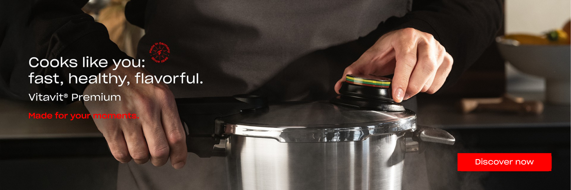 A home cook prepares a meal with a Fissler Vitavit Premium stainless steel pressure cooker in a contemporary kitchen, highlighting German precision and craftsmanship. On-screen text states: “Cooks like you: fast, healthy, flavorful. Vitavit Premium. Made for your moments.” A distinctive red button invites with “Discover now.”.