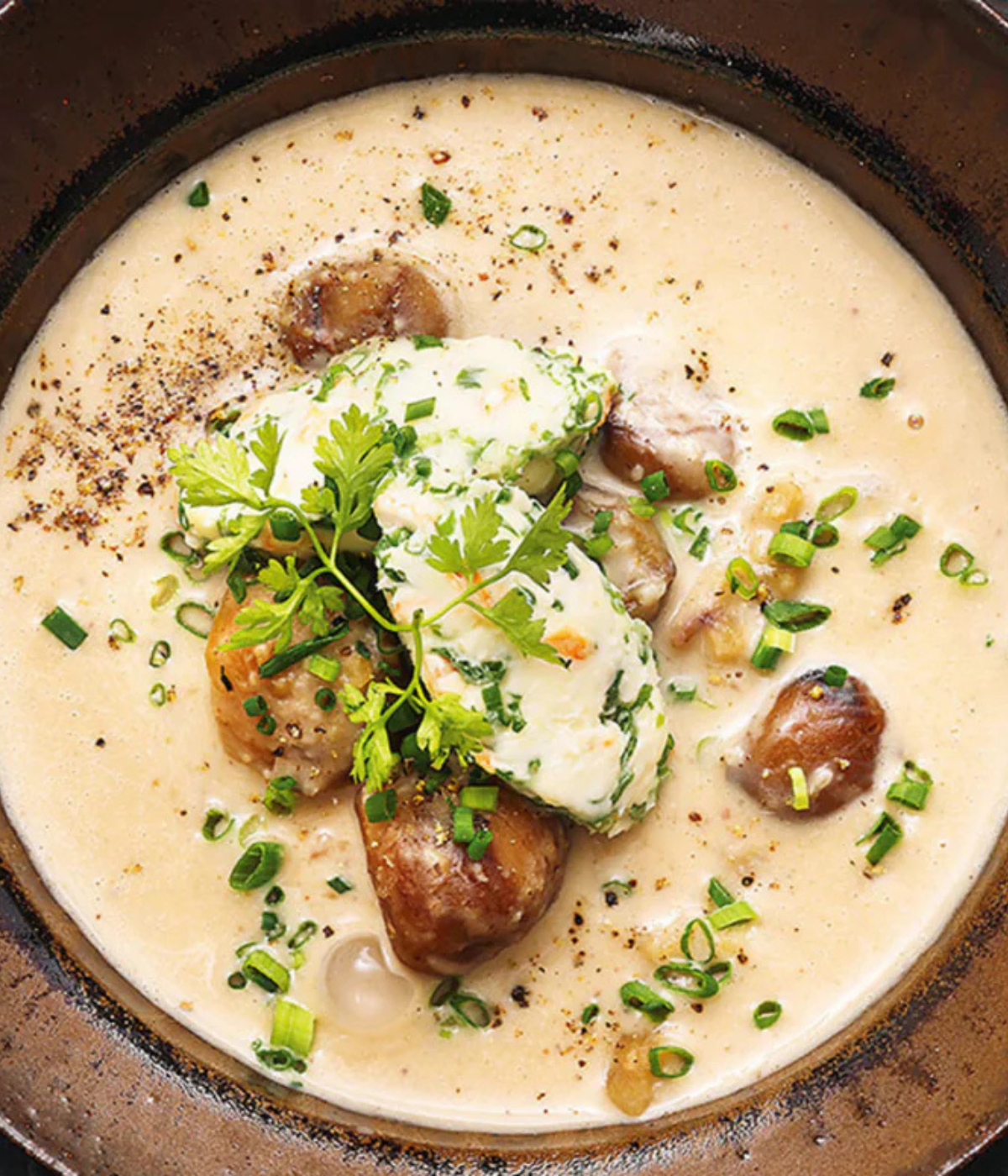 A creamy soup with meatballs, mushrooms, herbs, and spring onions - prepared with Fissler's precision cookware.
