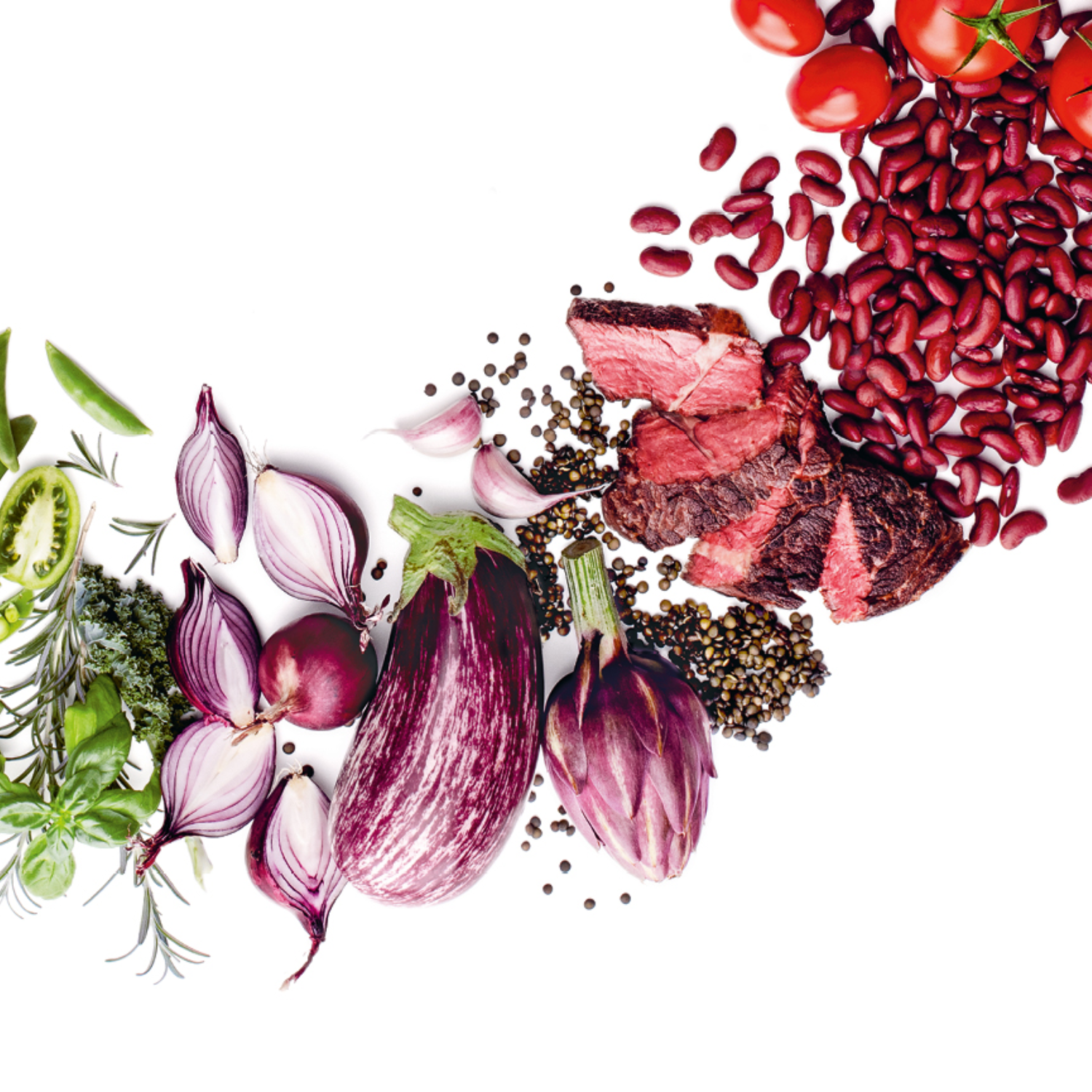 Fresh vegetables, herbs, and grilled steak, beautifully arranged to showcase the perfection of cooking with Fissler cookware.