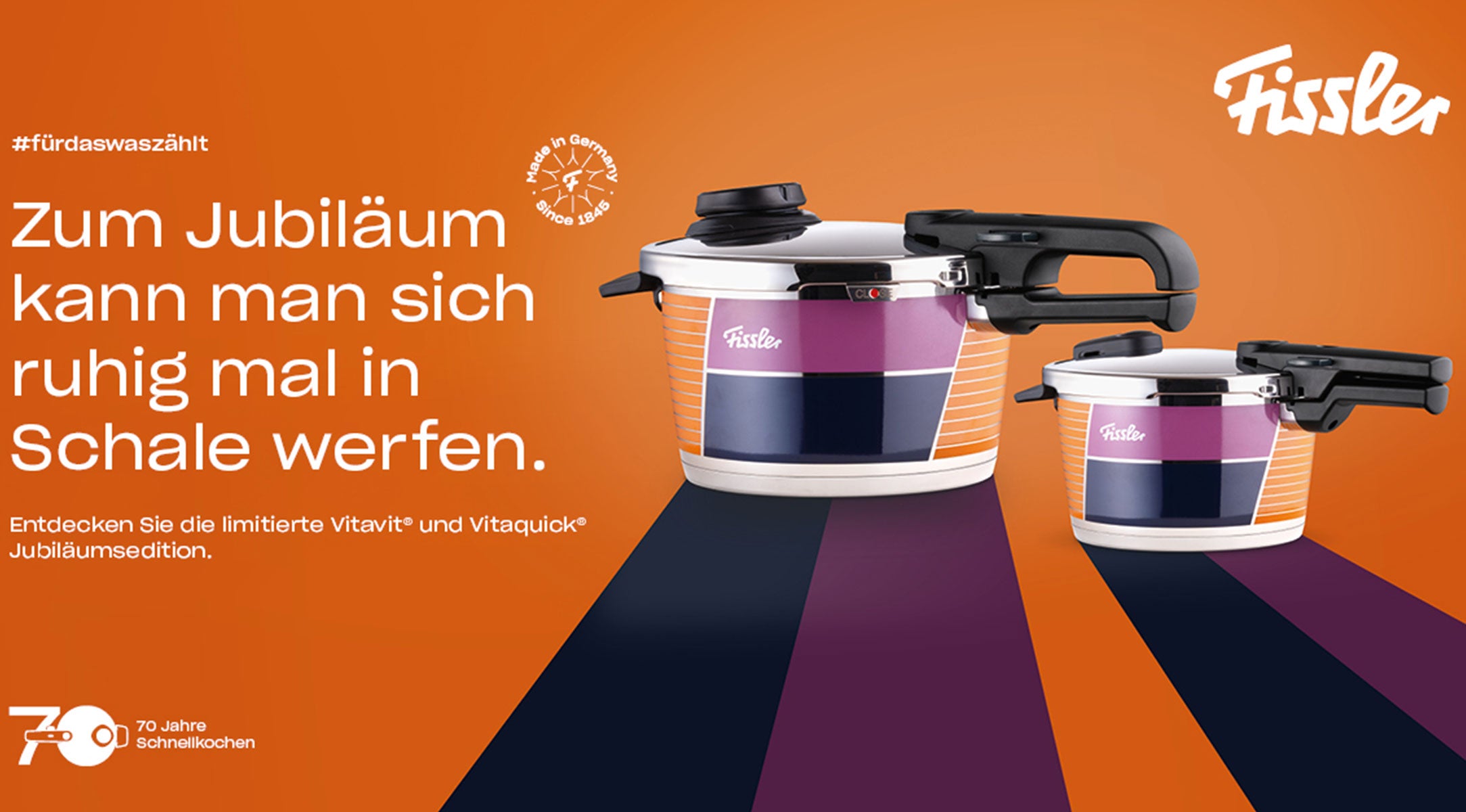 Zwei hochwertige Fissler Schnellkochtöpfe mit bunten Streifen feiern unser Jubiläum. Limitierte Auflage, deutscher Text, Fissler-Logo oben rechts.
